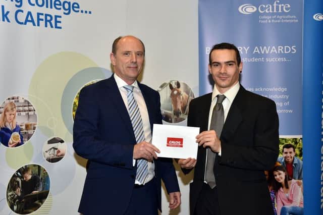 Horticulture student Jacob Sammons from Portrush receiving his bursary at the recent Bursary Awards event at CAFRE Greenmount Campus from Mark McClements of Calor.