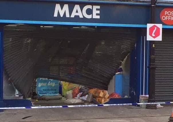 Police are appealing for information after a vehicle was deliberatley driven at the shutters of the store.