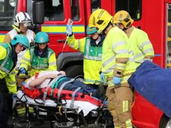 Man being helped from crashed car. Stock image