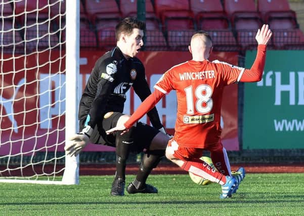 Jude Winchester slides home Cliftonville's opening goal at Solitude against Portadown. Pic by PressEye Ltd.
