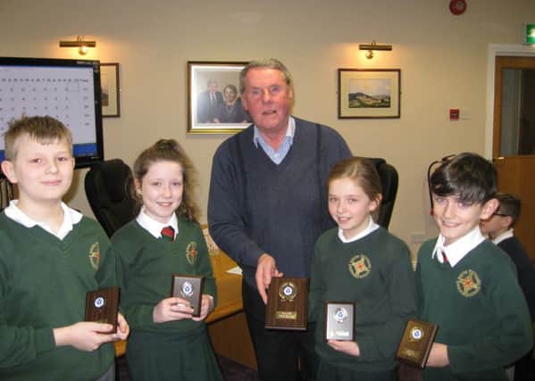 The winning team in the Credit Unio Quiz from St MacNissis pictured with the quiz master, Paul McCaughan.
