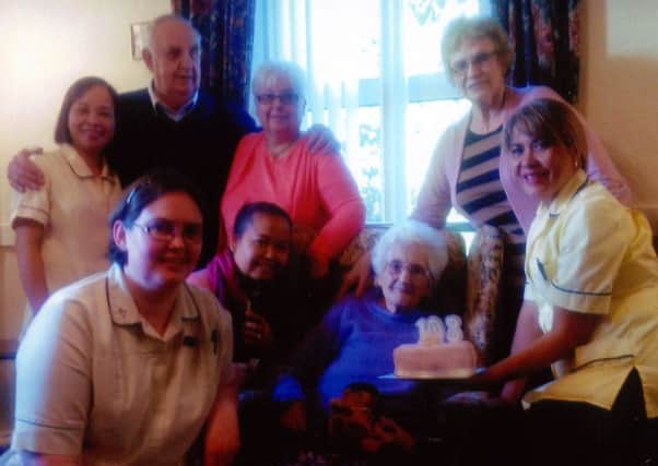 Staff of Glenview Care Home celebrate the 103rd birthday of Sarah Edgar, before she was transferred to a new home on Thursday. Centre back is her daughter Olive Lappin. INPT05