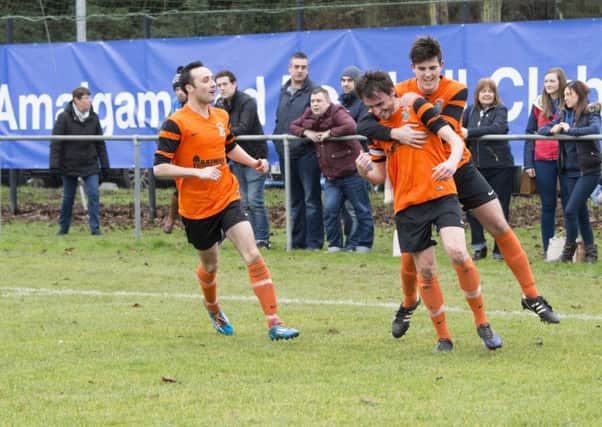 Dollingstown captain Aaron Moffett and team-mates celebrate the opening goal in a fifth-round victory over Richhill AFC.