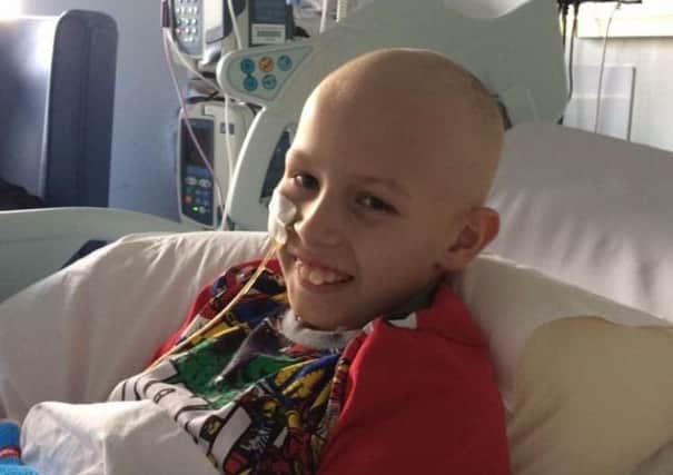 Jack Roycroft manages a smile in hospital during his intensive treatment