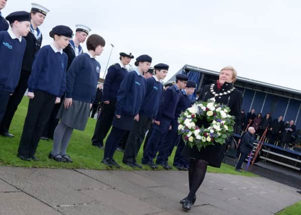 Mayor Audrey Wales lays a wreath in memory of the victims of the Princess Victoria tragedy as local Sea Cadets form a guard of honour. INLT-04-712-con