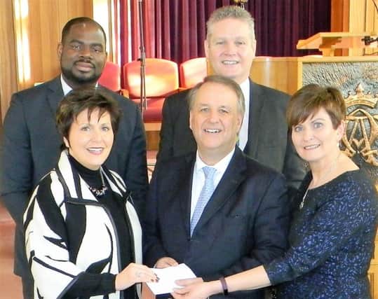Pastor Jon Ogle, Pastors Jonathan and Yvonne Payne, and Hilary Kyle from Ballymoney Church of God presenting a cheque to Richard Gunning from Reach the Unreached Ministries.