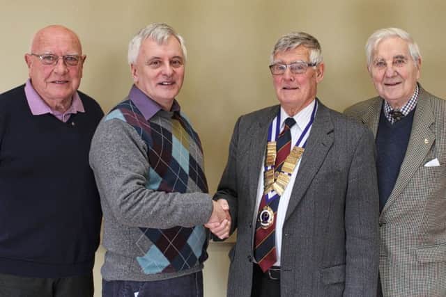 Coleraine Probus President Jim Archer greets Alan Devers with club members Billy Platt (L) and Norman Maxwell (R).