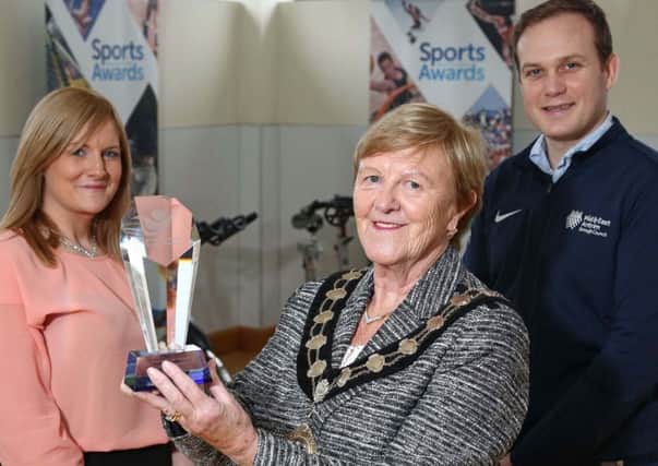 The Mayor of Mid and East Antrim Borough, Cllr Audrey Wales MBE admires one of the trophies as final preparations are made for the Mid and East Antrim Borough Council Sports Awards. Looking on are Katrina McCaughan and Colin Roden, both Sports Development Officers Mid and East Antrim Borough Council. Picture by Darren Kidd / Press Eye.