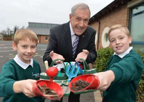 Cllr Uel Mackin, Chairman of the council's Development Committee, is pictured with green-fingered pupils Jonathan Allen and Cameron Stirling at Meadow Bridge Primary School.
