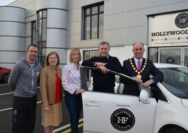 Niall Hollywood, left, pictured with local politicians as he hands over the car his gym bought for LiLAC with Flogas