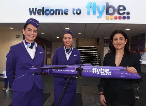 Kerry Craig (left) from Ballymoney and Laura Thompson (centre) from Portavogie, get their Flybe Ã¢Â¬ÃœWingsÃ¢Â¬" from Christine Ourmieres-Widener, the airlines new Chief Executive Officer.