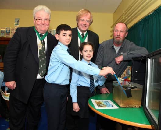 Pictured during the salmon hatchery in the classroom programme (sponsored by The Honourable The Irish Society) at Kilrea Primary School are P.6 pupils Henry and Charlotte with Roger Chadwick, Deputy Governor Hon. The Irish Society, Sir David Wootton, Governor Hon. The Irish Society, and Mark Patterson, angling consultant.