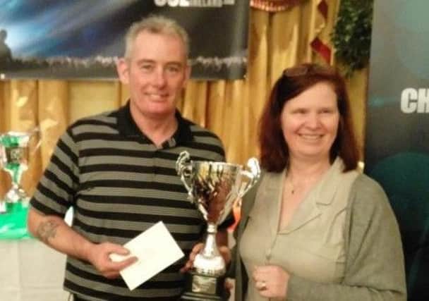 Raymond Stockman is presented with the trophy after winning the Irish Blackball National Seniors Individual title at the weekend.