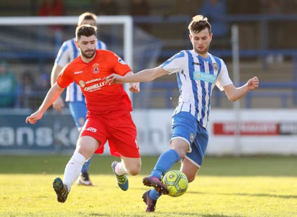 Coleraine's Adam Mullan with Dungannon's Cormac Burke during Saturday's Danske Bank Premiership game at the Showgrounds, Coleraine. Photo by William Cherry/Presseye