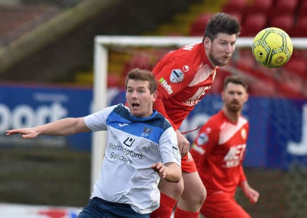 Ken Oman - who was sent off for Portadown in the first half - winning the ball over Ards' Ross Arthurs at Shamrock Park. Pic by PressEye Ltd.