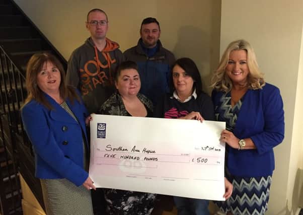 Members of the Winton family present a cheque for Â£500 to the Southern Area Hospice. Included are (front row, left to right): Tania Bailie, Hospice Regional Marketing Officer; Karen Winton; Kerry Patterson and Jo-Anne Dobson. Back row: Craig Winton and Robert Winton.