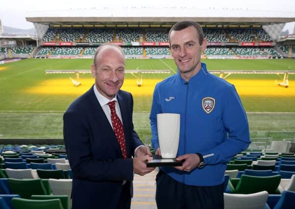 Oran Kearney receives the Manager of the Month award from NIFWA Chairman Stephen Watson.