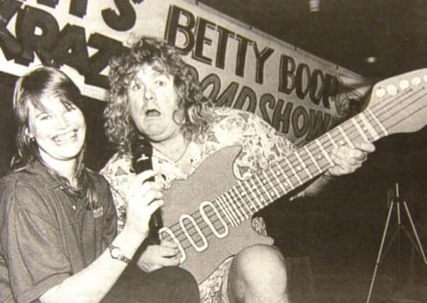 Joanne Turner of Jameson's Bar, Portadown, serenaded by DJ "Krazy" Kenny Gregg at the launch of the venue's new nightspot in 1997.