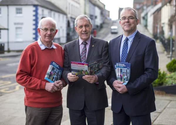 Chair of the council's Development Committee, Councillor Uel Mackin (centre) with Hillsborough Steering Group members Robert Lucas and Jeffrey Reaney.