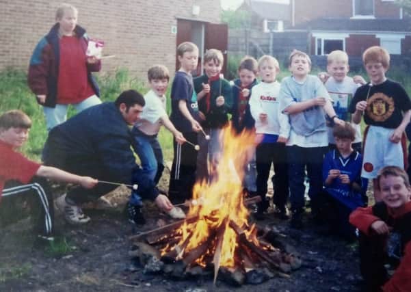 Members of the Cub Pack making toasted marshmallows, circa 1997.
