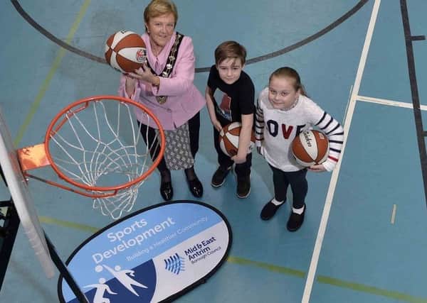 Lily and Michael from St. Brigids and from Ballykeel Primary Schools help Mid and East Antrim Borough Mayor, Councillor Audrey Wales MBE take a shot or two at the basket during PeacePlayers International-Northern Irelands innovative Basketball Twinning Programme for schools in the Ballymena area. Presseye picture by Stephen Hamilton