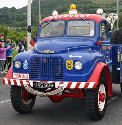 East Antrim Old Vehicle Club lead the way for the Olympic Torch. INNT 23-027-FP