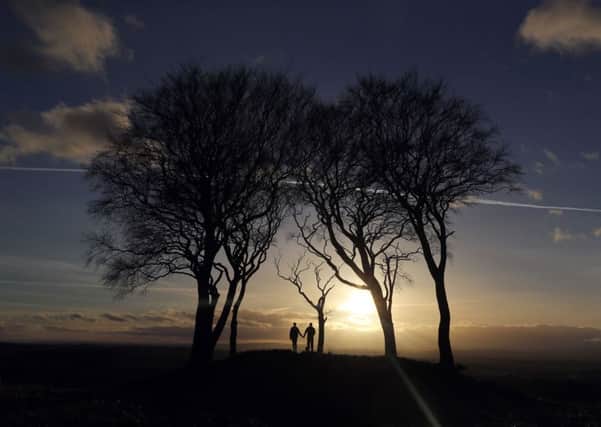 The sun sets behind the Seven Sisters round barrow, at Copt Hill, Houghton-le-Spring, during unseasonably warm weather  across the UK. Picture date: Monday February 20, 2017.