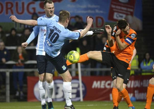 Carrick Rangers captain Mark Surgenor (right) and former Ballymena United team-mate Allan Jenkins battle for the ball on Saturday in the League Cup final. Pic by PressEye Ltd.