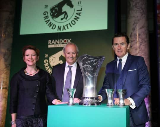 Dr Peter FitzGerald with the trophy designer Shannon ONeill and Sir Anthony McCoy at the Randox Health Grand National Weights Reception.  (Submitted Picture)