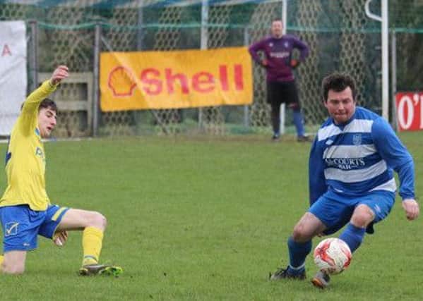 Ardmore Reserves' Barry Gormley (Blue & White Hoops) skips away from his Roe Rovers marker.