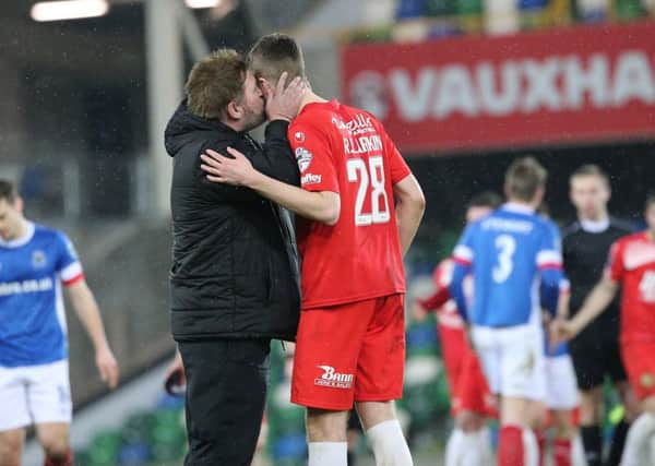 Portadown manager Niall Currie and teenage centre-back Ross Larkin celebrate Friday's 1-1 draw against Linfield. Pic by Pacemaker.