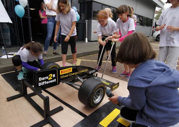 Dare to be different girls learning how to wheel change.