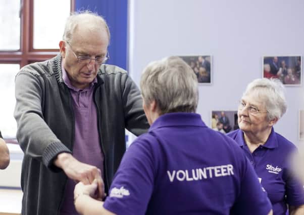 Volunteers from the Stroke Association help with rehabilitation.