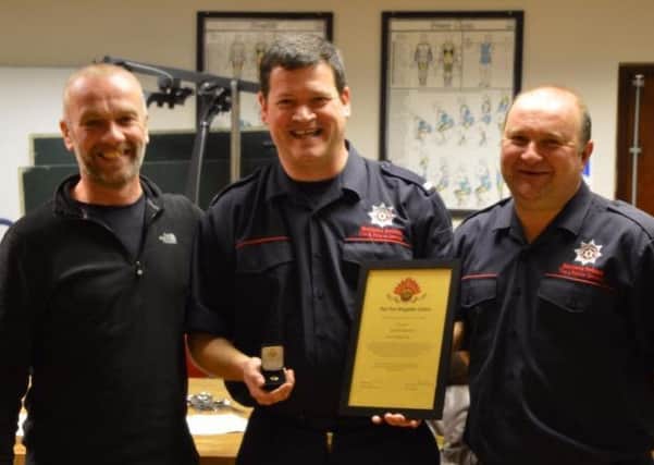 John Catterwood (left), regional chairman of the Retained Service with Larne fire fighters Alistair Carmichael (centre) and Paul Henderson.