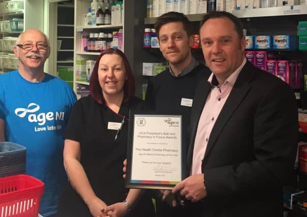 Kevin Wilson (left), who manages the Age NI store in Carrickfergus, presents the Age NI Referral Pharmacy of the Year award to Emma Templeton, Adam Bartholomew and Jonathan Lloyd from The Health Centre Pharmacy, Carrickfergus. The pharmacy team was recently recognised for its charitable support to Age NI in 2016 during the 10th Annual Ulster Chemists Association (UCA) Presidents Ball and Pharmacy in Focus Awards. (submitted Pic).