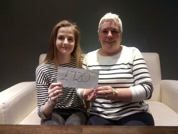 Emily Bradley presents Angela Chambers from Action Cancer with Â£720.