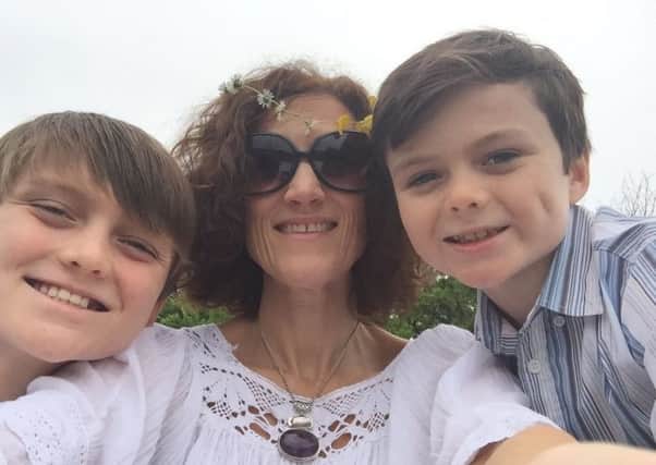 Cancer survivor Jill Pearson, from Randalstown, who is dancing to support cancer patients, pictured with sons Harvey (left) and Jacob.