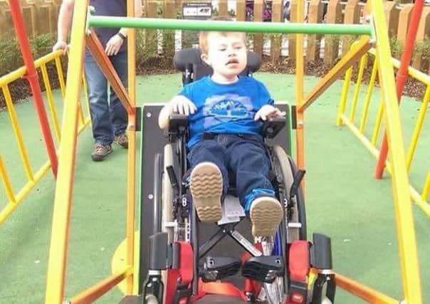Luke enjoying a wheelchair swing in Portstewart.