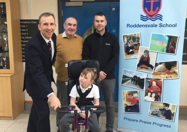Richard and Raymond Lusty pictured with Vida on a therapy bike at Roddensvale School. Included is principal John Madden.