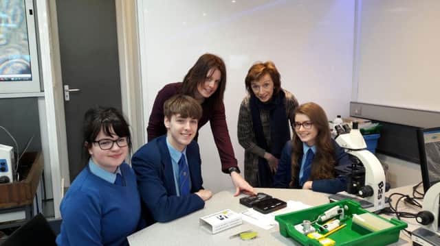Loreto College Head of Biology Mrs Geraldine Doherty assists STEM Module facilitator and students Connie Baxter Mulvenna, Cain McKendry and Caitlin Cosgrove during their A Level Biology workshop.