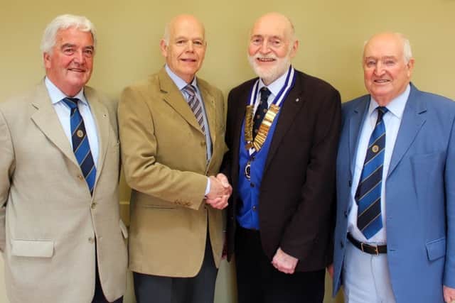 Coleraine Probus President Mike Turner greets club member Derick Woods, with members Des Johnston (L) and Eric Fulton (R).