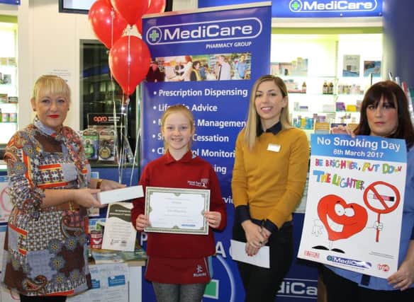 Jena Magowan receives her prize from staff at MediCare Pharmacy, Market Lane, Lisburn. Pictured (l-r) are Zoe Templeman, Jena Magowan, Clare Hunter and Sheena McBride.