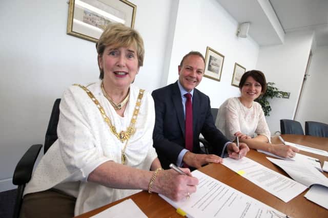 The Mayor of Causeway Coast and Glens Borough Council, Alderman Maura Hickey, signs the contract for Northern Ireland's first carrier-neutral enterprise zone, which will be located in Coleraine, with Karise Hutchinson from Ulster University and Paul Beazley,from 5nines, the anchor tenant on the site. PICTURE KEVIN MCAULEY/MCAULEY MULTIMEDIA/CCGBC.INCR 11-759-CON