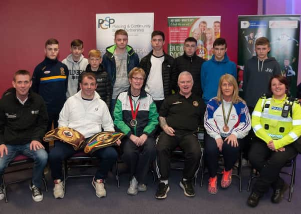 Several local sporting personalities also showed their support for the youth project by attending the event. Pictured with Stephen Sheerin, PCSP Partnership Officer, seated extreme left, are Eamonn Loughran world champion boxer with his awards. He is beside Barbara Cameron, Commonwealth Bowls winner and  Billy O'Flagherty Club Secretary is also shown, seated, third from right. Constable Joanne Campbell, Ballymena PSNI is on right beside Jacquie McWilliams Olympic Hockey Medal winner. A number of the 'Teenage Kicks' participants are also pictured, back row.