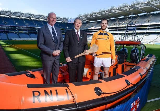 Red Bay RNLI volunteer Paddy McLaughlin and Antrim champion hurler Neil McManus with broadcaster MÃ­cheÃ¡l " Muircheartaigh at the Croke Park launch of the RNLIs partnership with the GAA to prevent drowning. INBM 11-709-CON