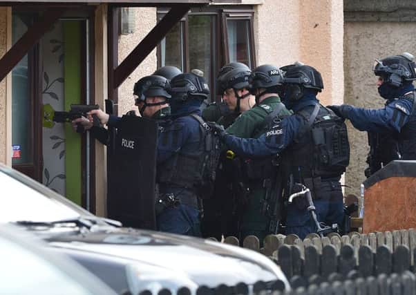 Heavily armed specialist police raid a house near the scene of a shooting in Carrickfergus. Photo: Arthur Allison/Pacemaker Press