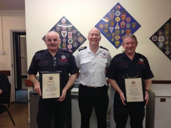 Ian & Sam being presented with their retirement certificates by District Commander Colin Dickson.