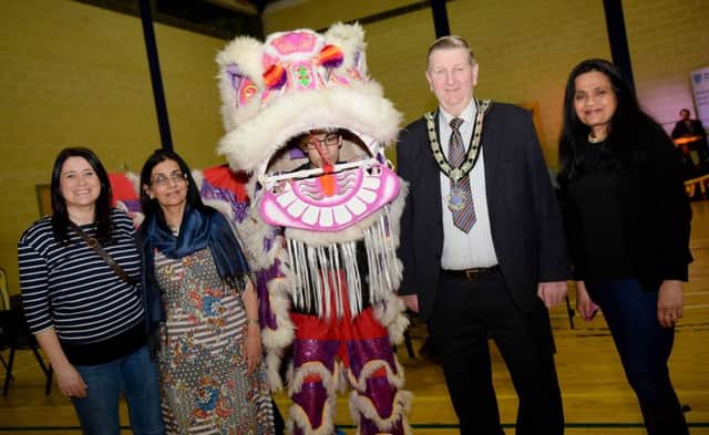 Alderman William McNeilly, Deputy Mayor of Mid and East Antrim meets the Chinese Lion with Ivy Goddard MBE from the Inter-Ethnic Forum (MEA), Nisha Tandon MBE (ArtseKta) and Jane Dunlop (Good Relations Officer for Mid and East Antrim Borough Council).