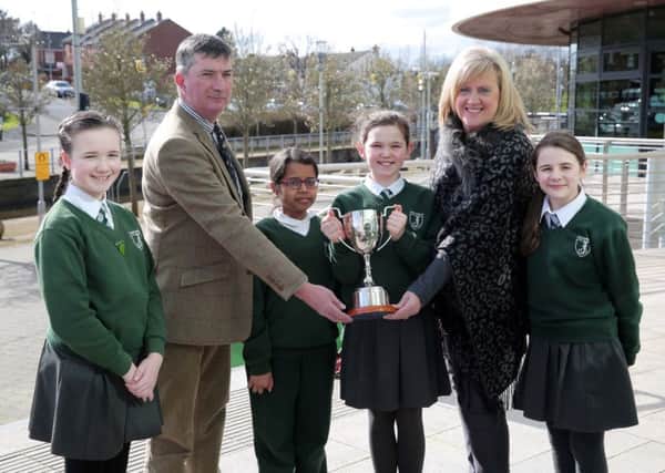 Winner of the Junior Section, Olivia Knight from St Joseph's Primary School, Carryduff pictured with her classmates and Councillor James Baird, Chairman of the council's Environmental Services Committee and Heather Moore,  Director of Environmental Services.