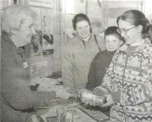 Carole Blair of CB Crafts shows glassware to Country Market customers in Larne TIC. 1997